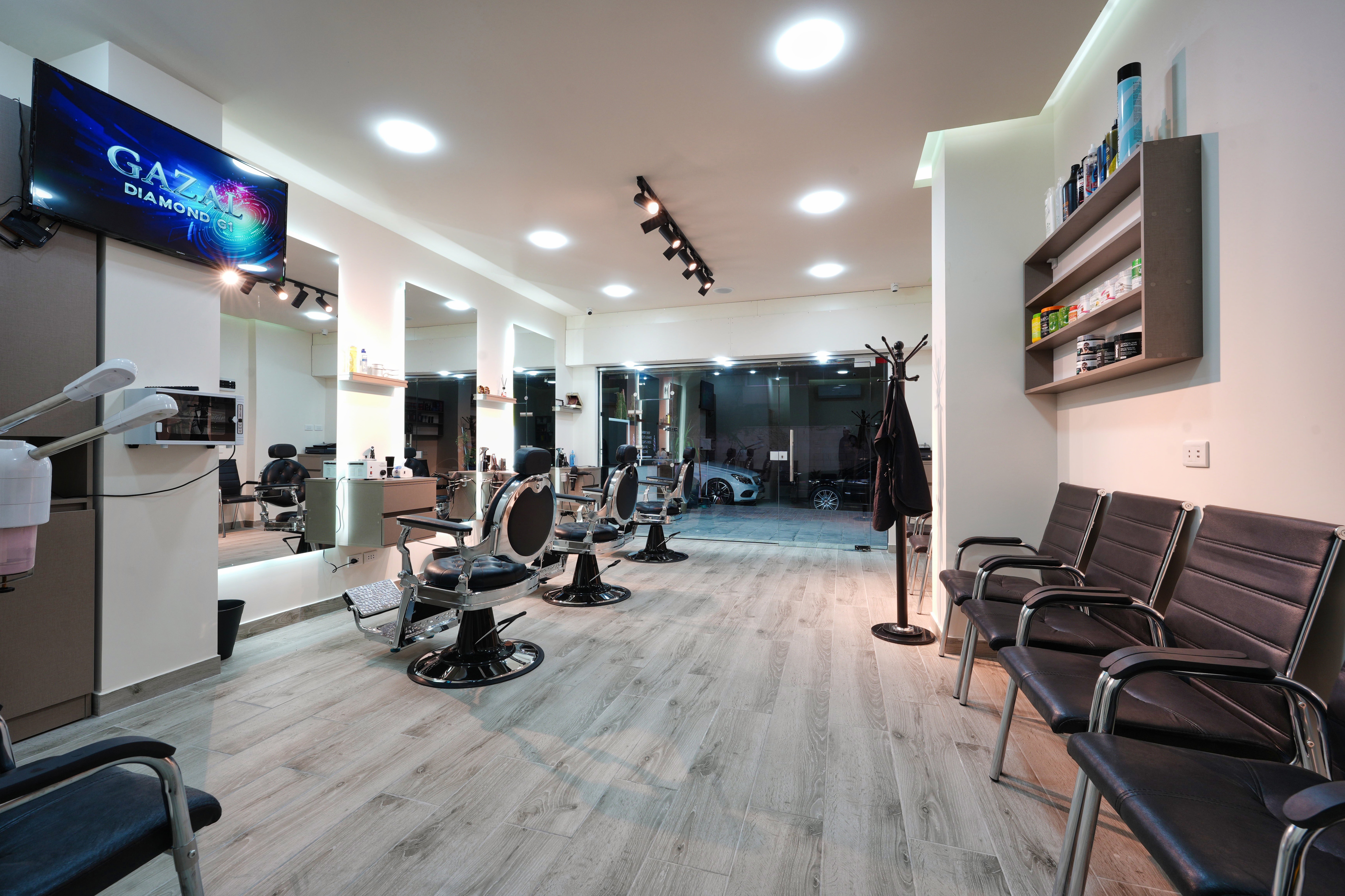 Bright, modern interior of The Barber Shop with wood floors and a waiting area