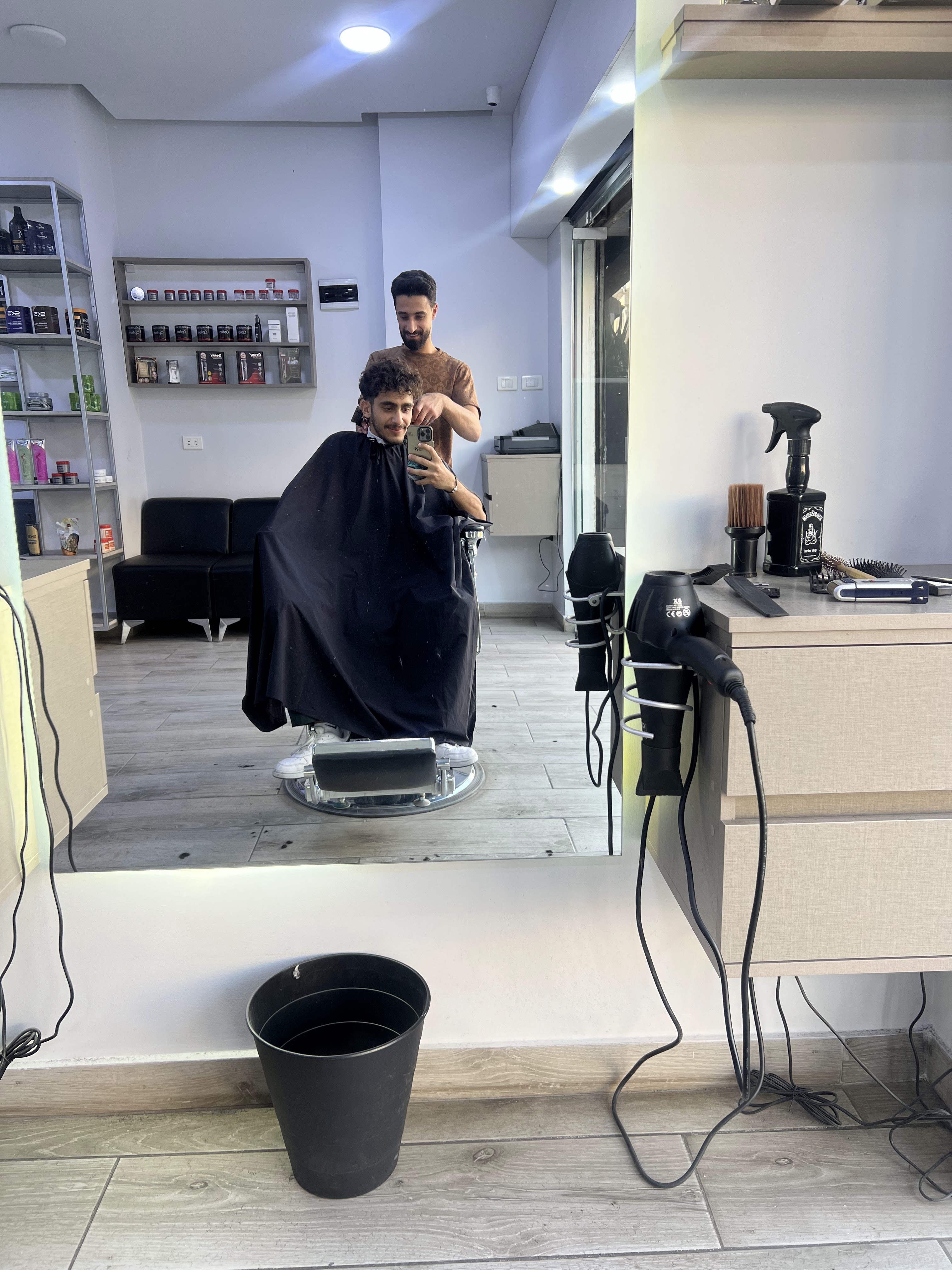 Client mirror selfie mid-haircut at The Barber Shop