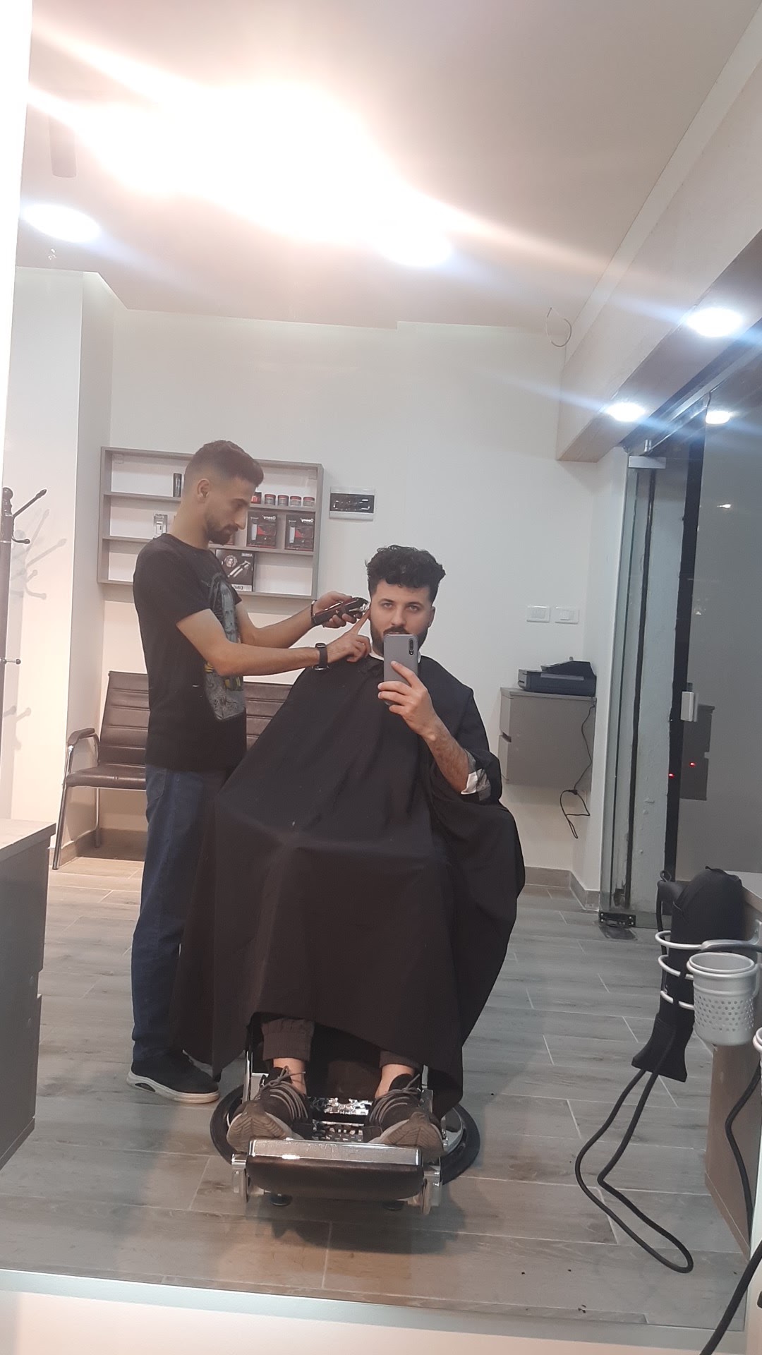 Barber detailing a client's haircut near the ear
