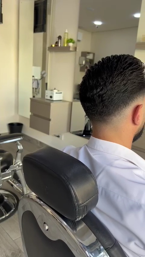 Finished clean fade result, viewed from behind at The Barber Shop